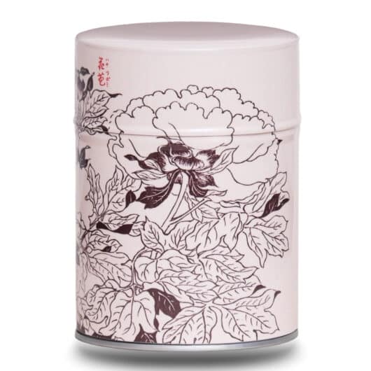 Metal tea caddy illustrated with a design of Japanese flowers with Japanese characters on a pink/beige background